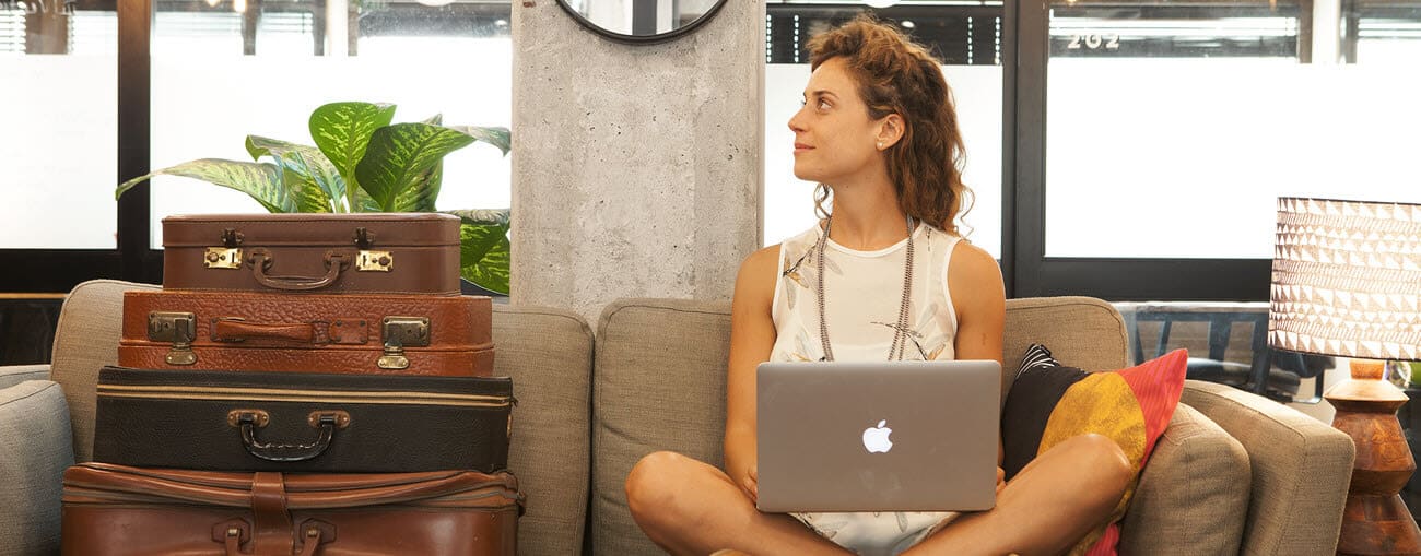 Person sitting on a sofa with a laptop